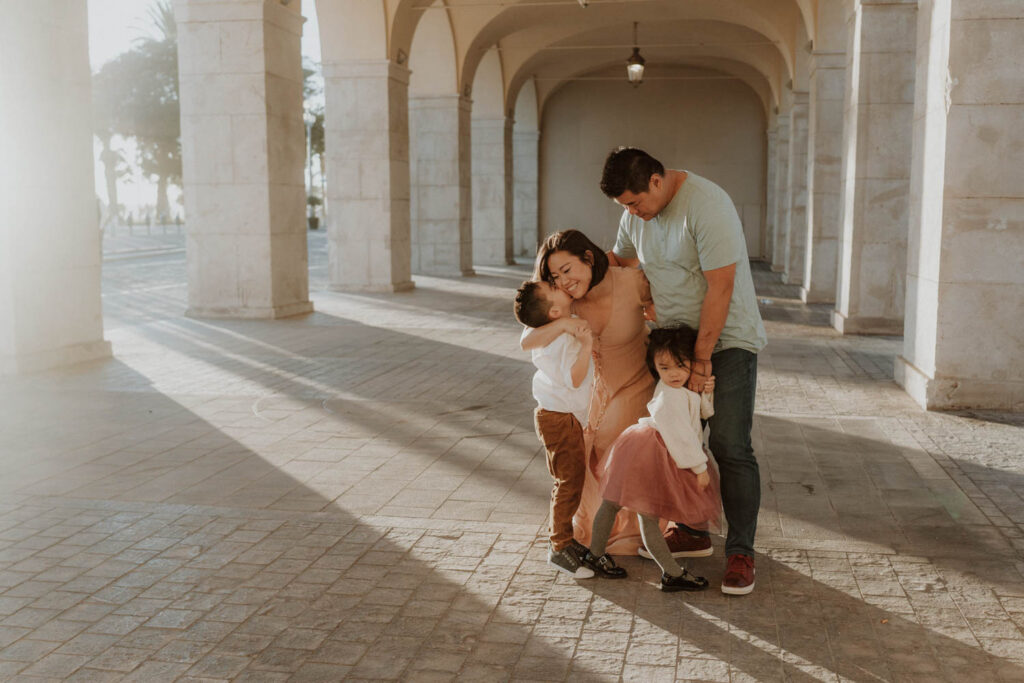 A family cuddling under the arcades in Nice